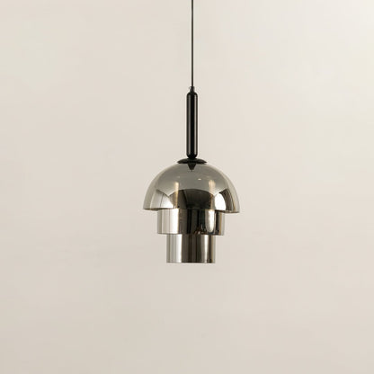 Silver metal pendant light shown unlit on white background highlighting dome shape polished finish and contemporary lighting style.