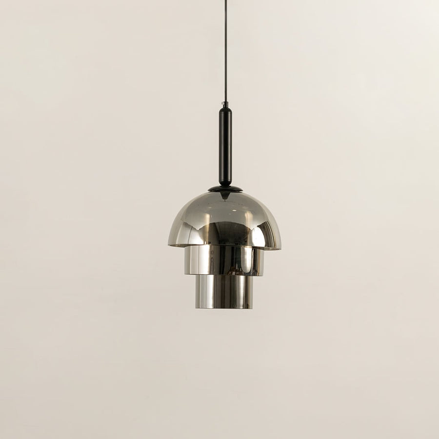 Silver metal pendant light shown unlit on white background highlighting dome shape polished finish and contemporary lighting style.