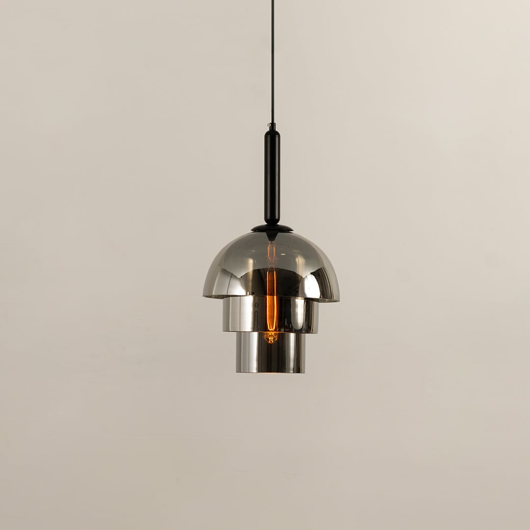 Chrome pendant light with a polished dome shade reflecting its surroundings while casting a warm downward glow that adds a sleek contemporary touch to the interior.