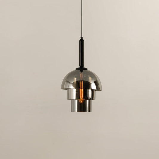 Chrome pendant light with a polished dome shade reflecting its surroundings while casting a warm downward glow that adds a sleek contemporary touch to the interior.