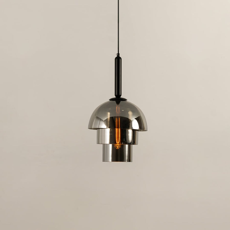 Chrome pendant light with a polished dome shade reflecting its surroundings while casting a warm downward glow that adds a sleek contemporary touch to the interior.