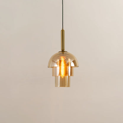 A gold glass pendant light displayed with lights on against a white background showcasing its layered dome design and warm glowing illumination.
