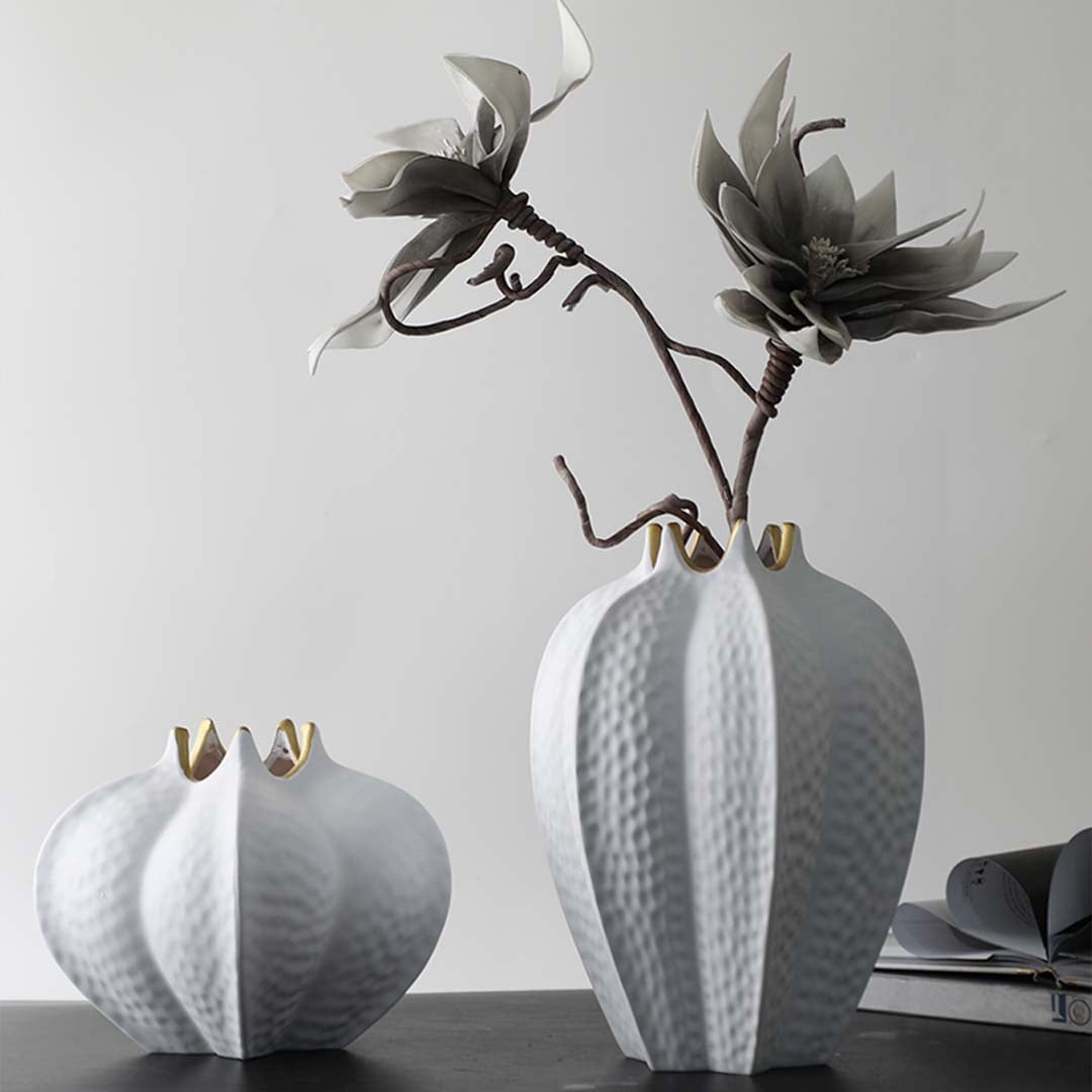 Set of white ceramic vases with textured surface and gold rim modern decorative accents for home styling.