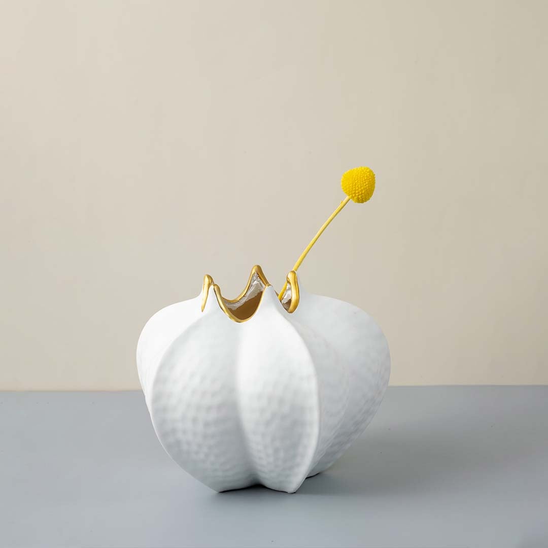 White textured ceramic vase gold accent modern living room decor Main Lifestyle image with single flower.
