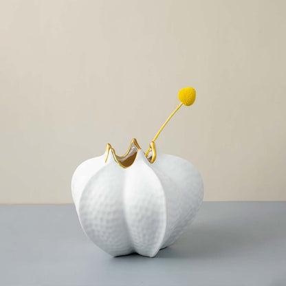 White textured ceramic vase gold accent modern living room decor Main Lifestyle image with single flower.