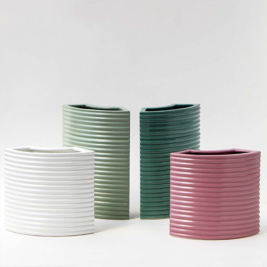 Contemporary mauve vase styled as part of a coordinated decor collection highlighting its ribbed curved front and modern silhouette for an elegant cohesive look.