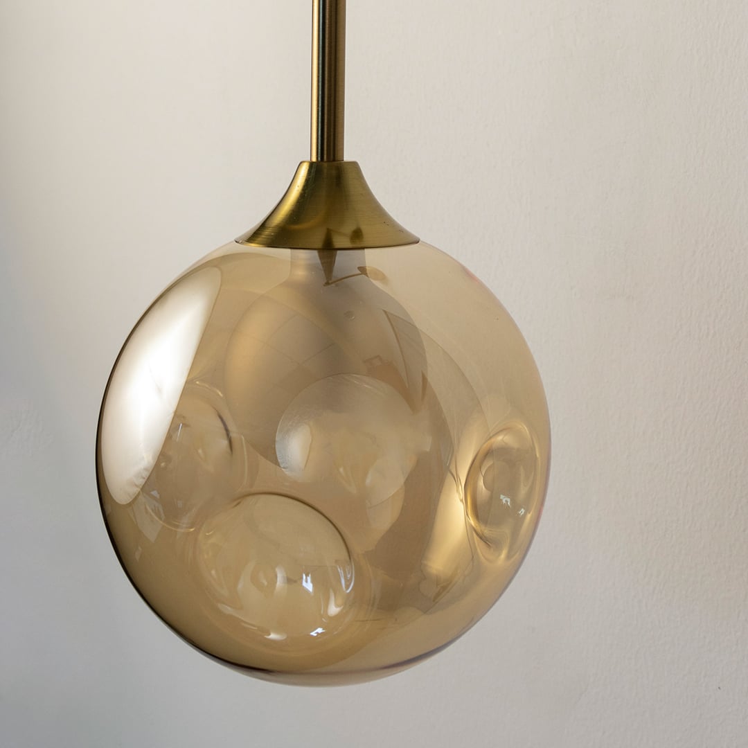 Closeup of gold glass wall sconce showing detailed texture and brass metal finish for premium modern home decor.