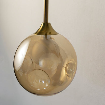 Closeup of gold glass wall sconce showing detailed texture and brass metal finish for premium modern home decor.