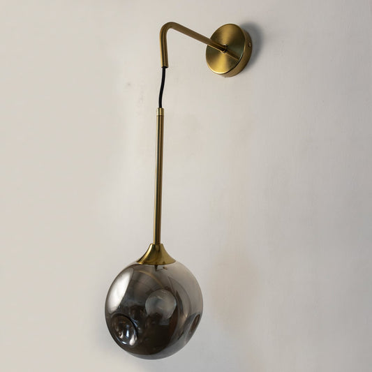 Elegant smoked glass and brass wall light on white background perfect for stylish contemporary living spaces.