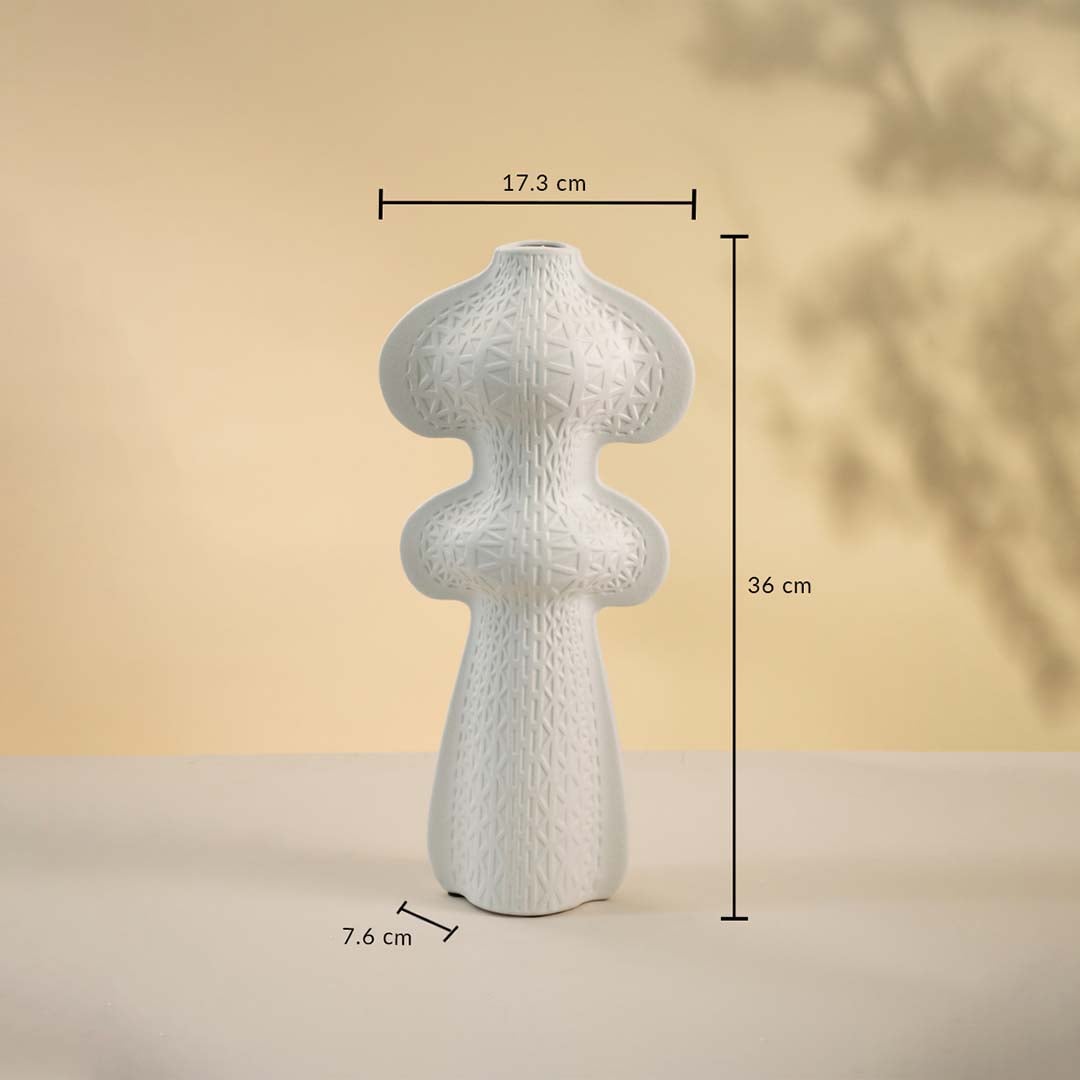White sculptural vase displayed on a neutral surface measuring 36 cm in height and 17 cm in width with a 7 cm base.