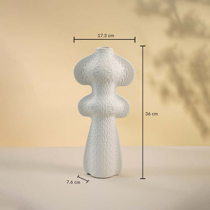 White sculptural vase displayed on a neutral surface measuring 36 cm in height and 17 cm in width with a 7 cm base.