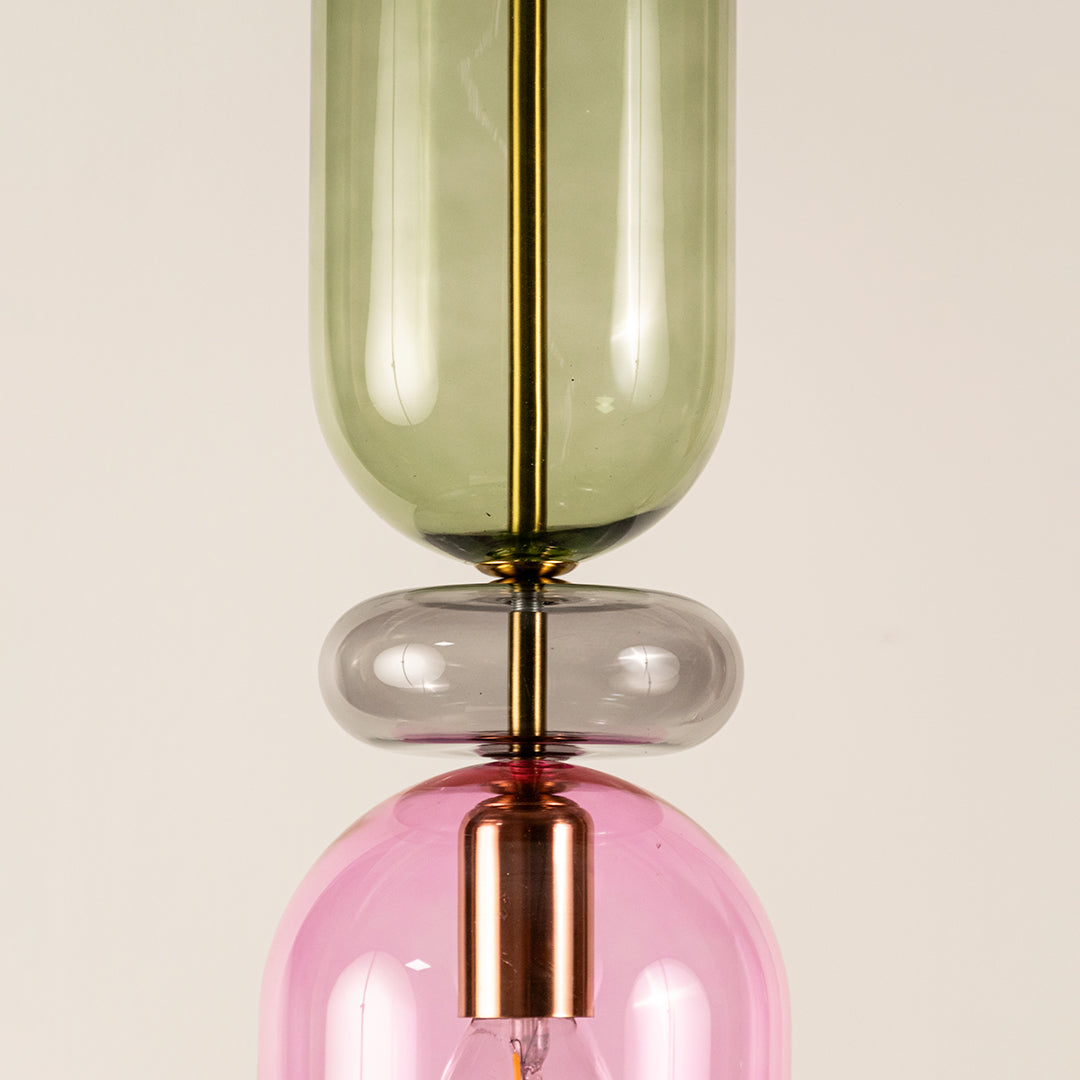 Green pink and smoke glass pendant light closeup showcasing layered glass design and premium decorative craftsmanship.