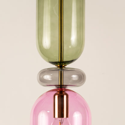 Green pink and smoke glass pendant light closeup showcasing layered glass design and premium decorative craftsmanship.