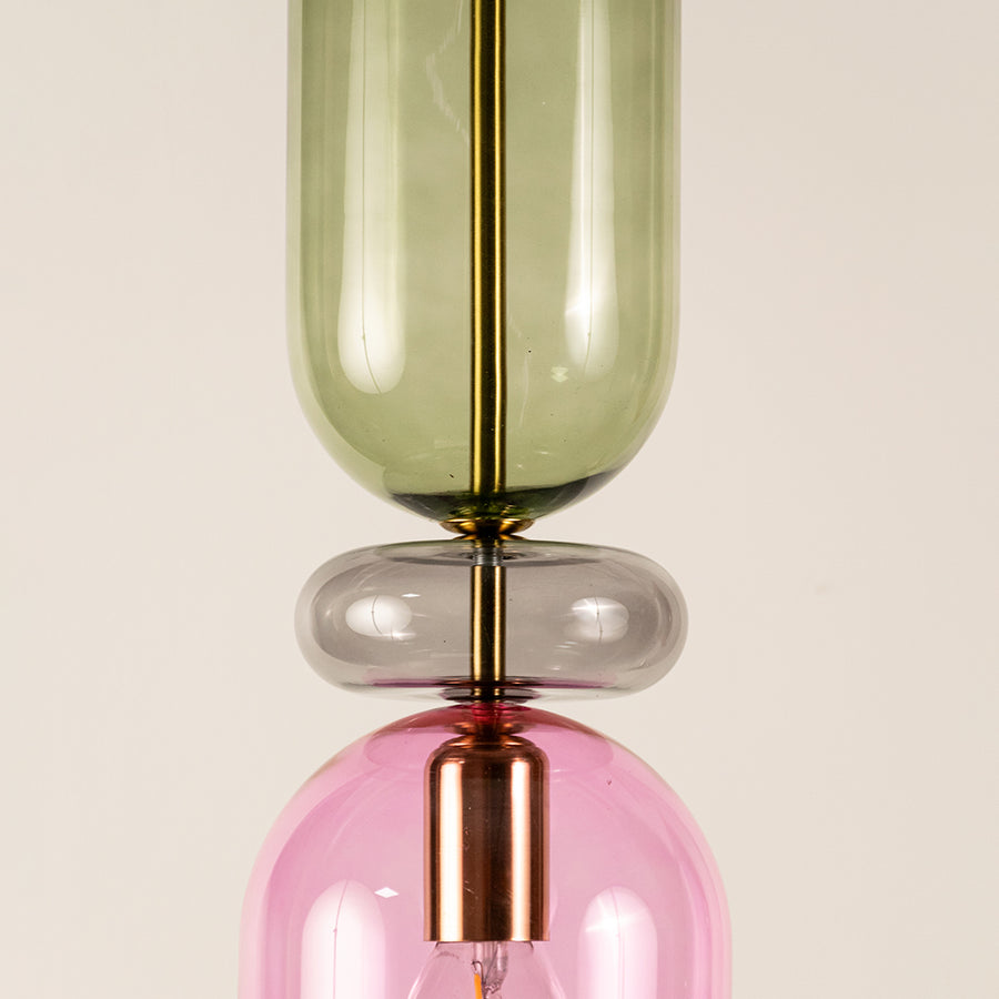 Green pink and smoke glass pendant light closeup showcasing layered glass design and premium decorative craftsmanship.
