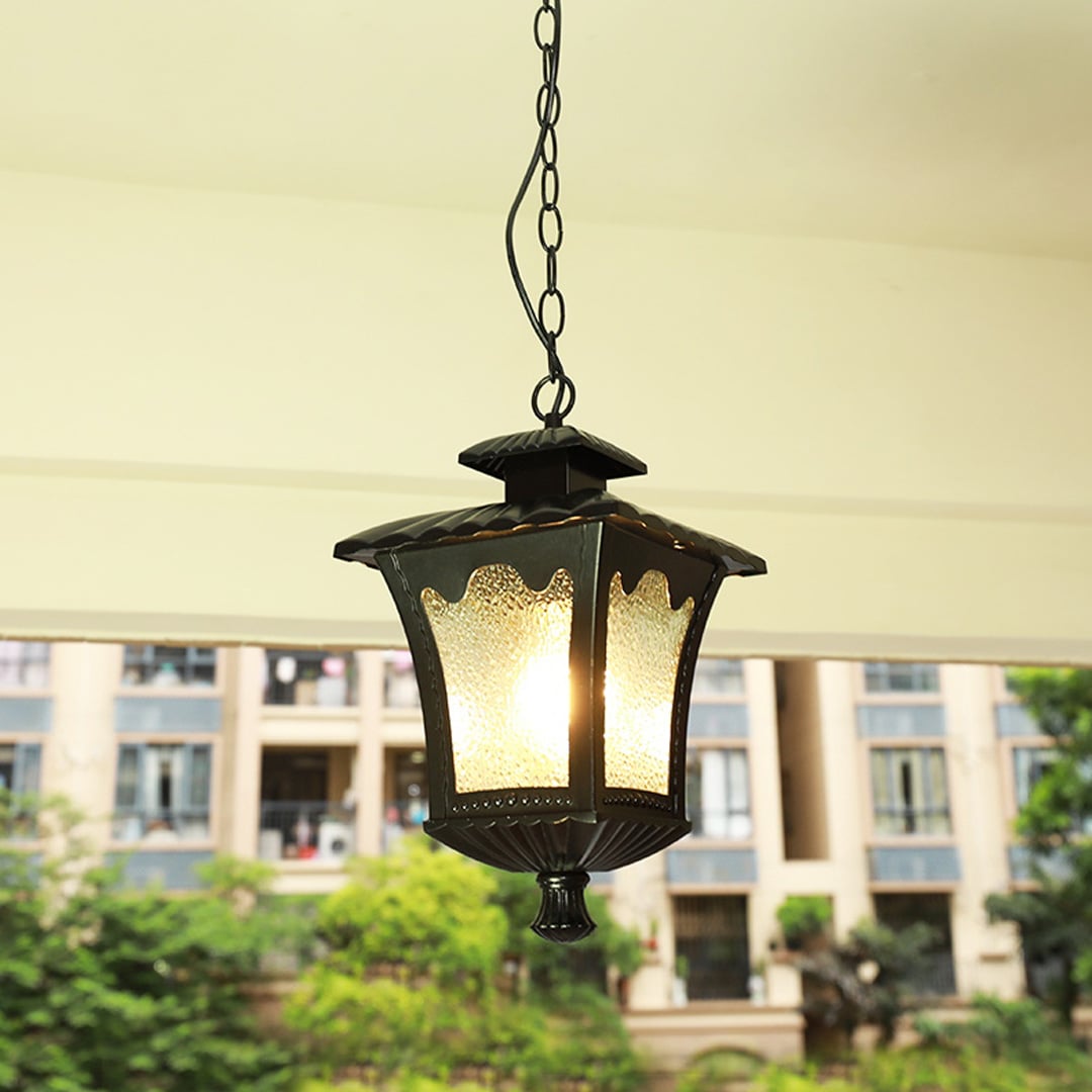 Antique black metal hanging lantern light enhancing modern balcony decor with warm ambient lighting.