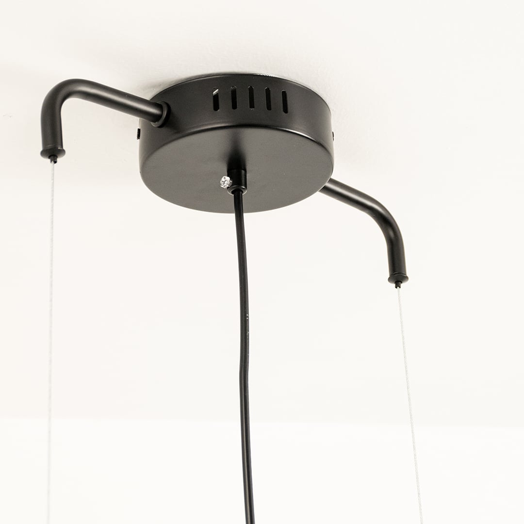 Close view of black ceiling mount chandelier showing smooth metal surface wire holders and precision craftsmanship for stylish lighting decor.