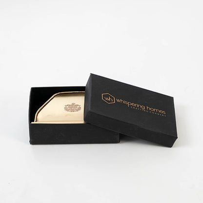 Main image of brass tissue holder with engraved crest flat base and antique finish shown with white napkins.