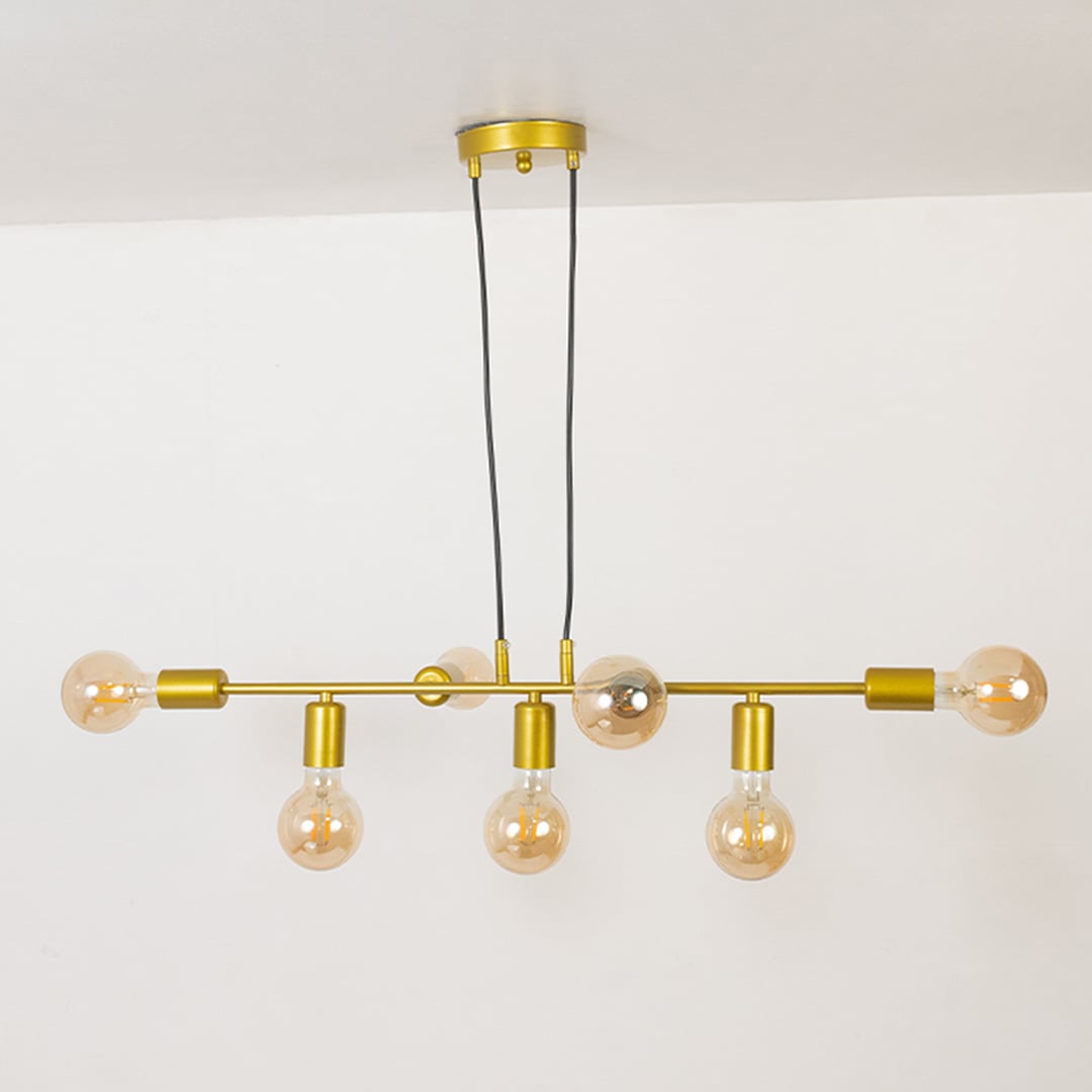 Modern linear chandelier with gold metal frame and exposed bulbs shown unlit on off white background for contemporary ceiling lighting.