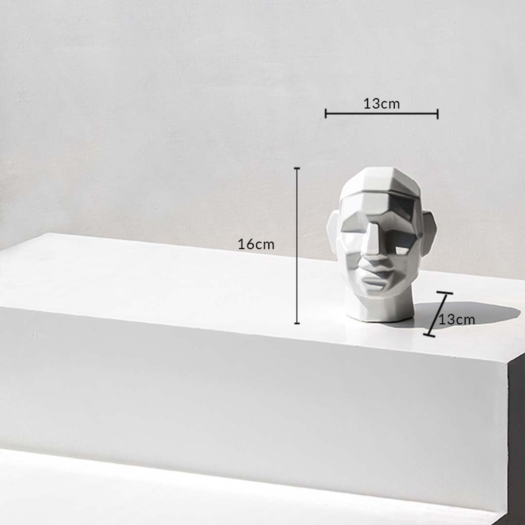 Geometric face sculpture with dimensions 16 cm height  13 cm width  and 13 cm depth shown on a white surface with measurement markers.