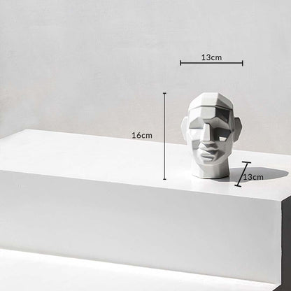 Geometric face sculpture with dimensions 16 cm height  13 cm width  and 13 cm depth shown on a white surface with measurement markers.