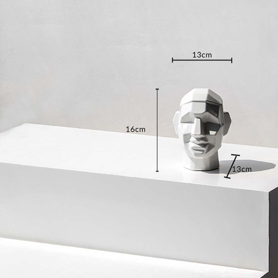 Geometric face sculpture with dimensions 16 cm height  13 cm width  and 13 cm depth shown on a white surface with measurement markers.