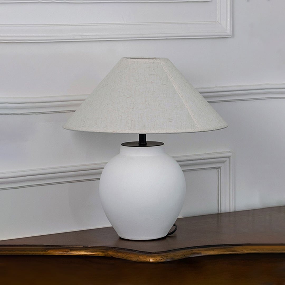 White ceramic table lamp with fabric shade creating refined ambient lighting and timeless traditional home decor appeal.