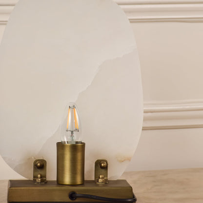 Closeup of marble table lamp showing natural veining and brass base craftsmanship reflecting premium quality and elegant design.
