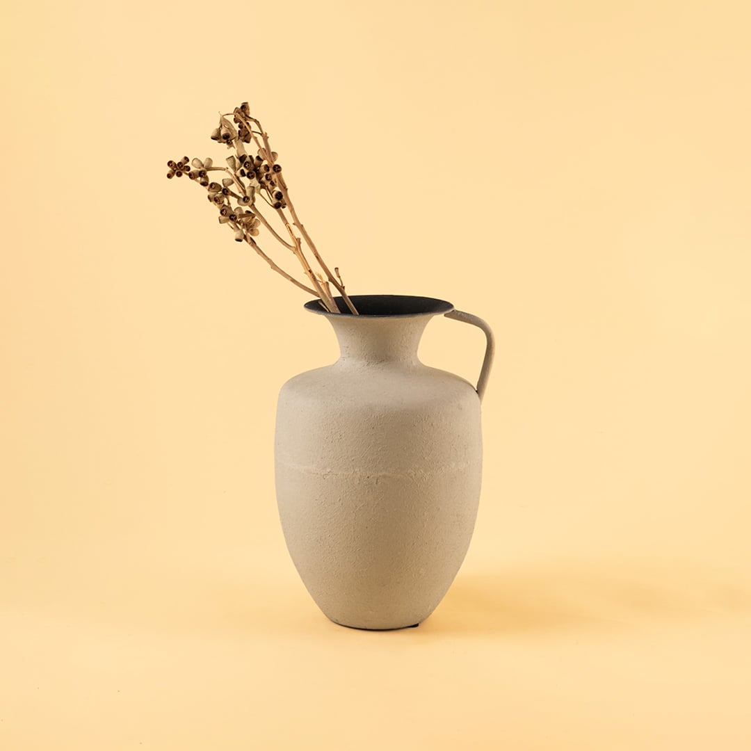 Cream metal jug vase decor styled in a warm modern room adding an elegant accent to living room tables and corner spaces.
