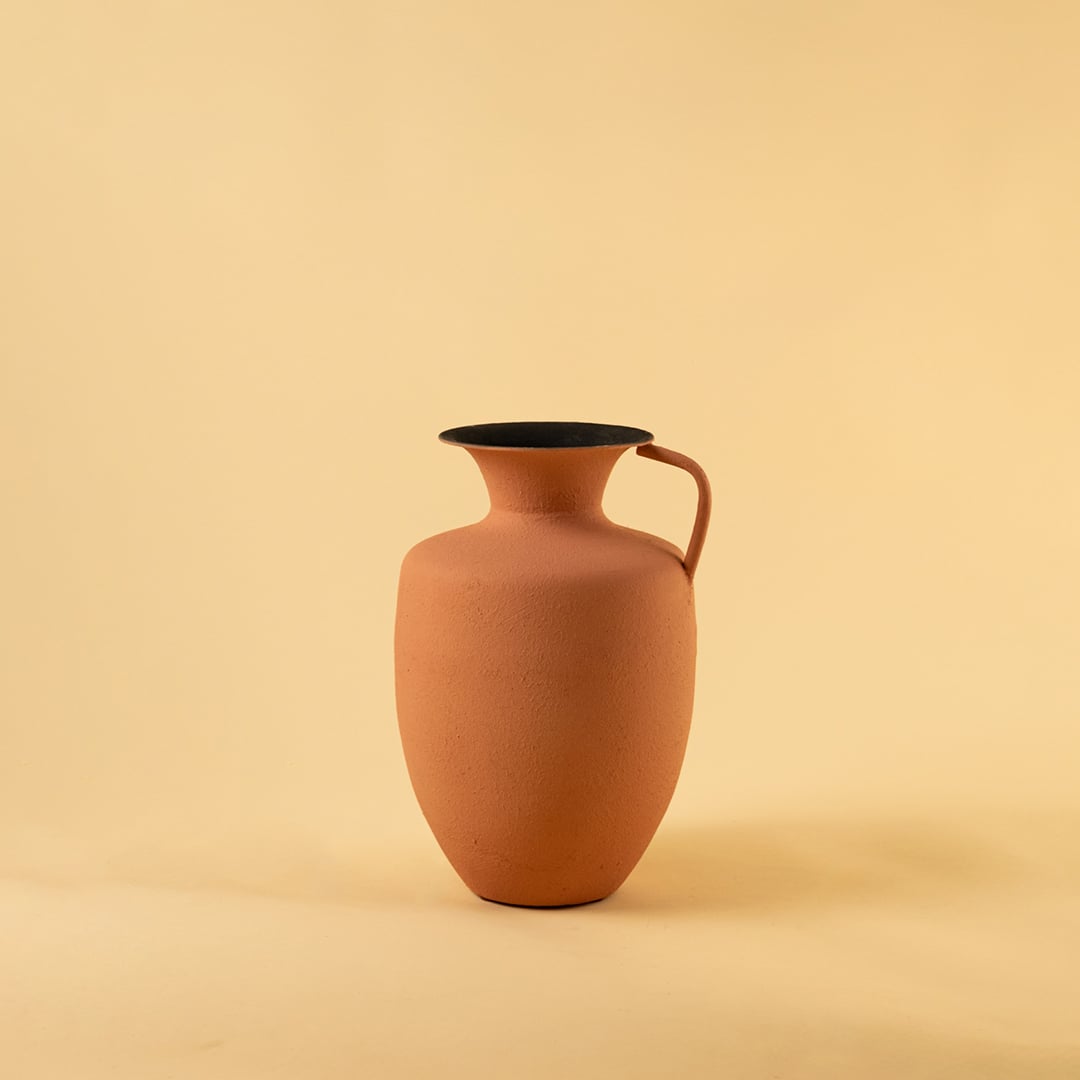 Terracotta metal jug vase decor on a clean white background highlighting its warm textured finish for versatile home styling.