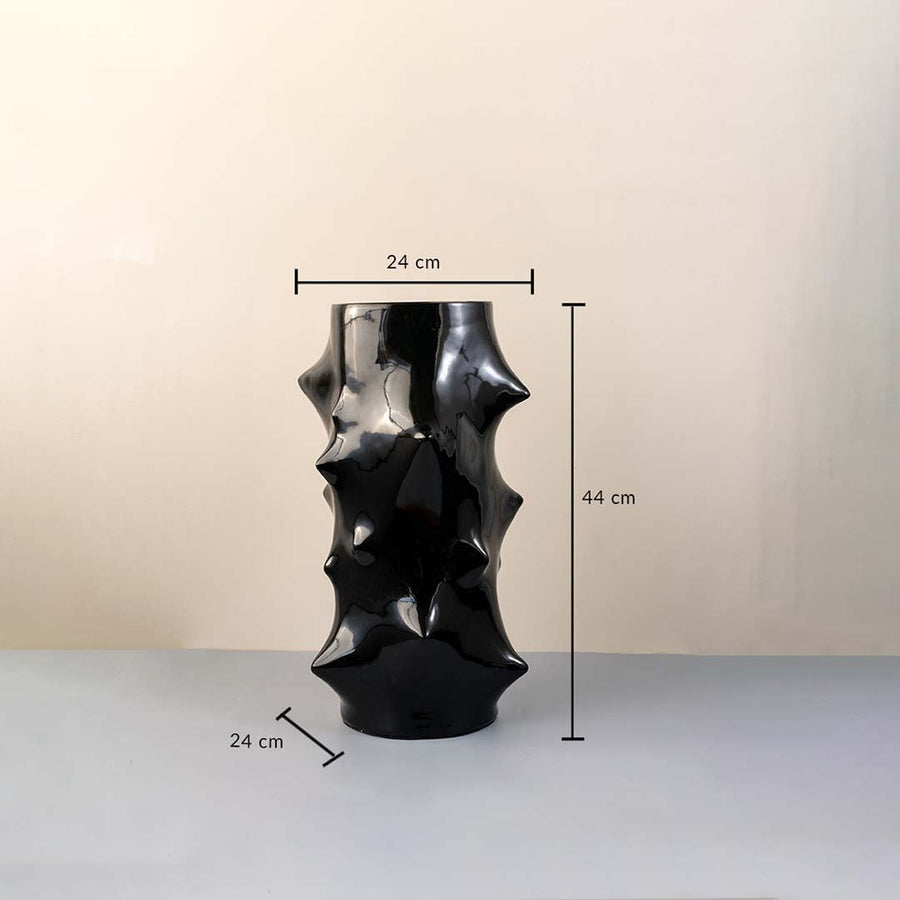 Black ceramic vase with glossy sculptural surface measuring 44 cm height and 24 cm width shown with dimension markings.