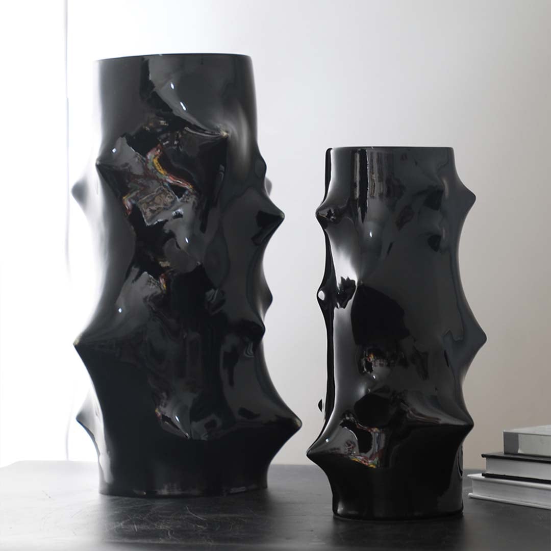 Collection of black ceramic vases with artistic sculptural shapes styled together for modern luxury table decor inspiration.