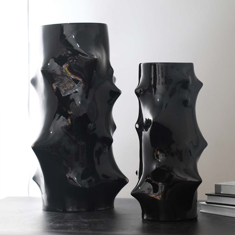 Collection of black ceramic vases with artistic sculptural shapes styled together for modern luxury table decor inspiration.