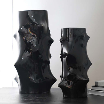 Grouped image of sculptural black ceramic vases with textured abstract forms styled together for bold modern home decor accents.