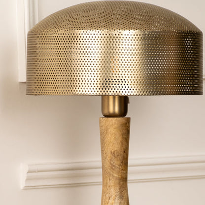 Closeup showing a metal shade and textured wooden base of table lamp reflecting expert craftsmanship and refined material contrast.