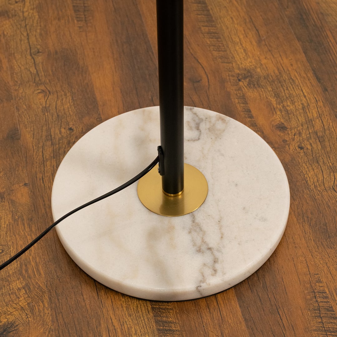 Closeup of globe floor lamp with white frosted glass globes and gold accents.