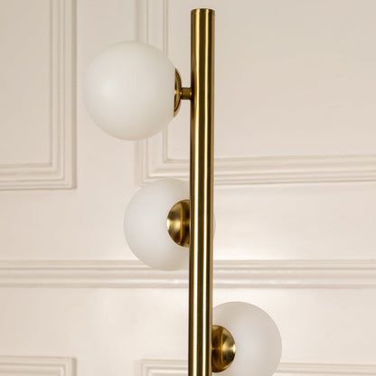 Detailed closeup of globe floor lamp globes and brass frame showing premium finish.