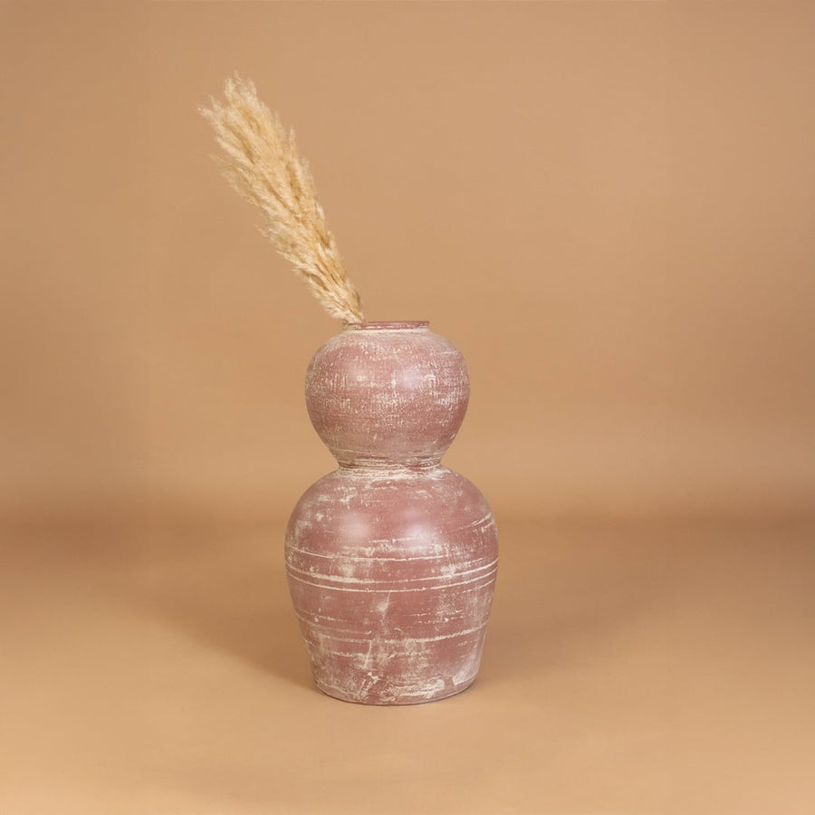 Rustic pink terracotta decorative vase placed in a styled interior adding earthy artistic decor to shelves consoles and contemporary living spaces.