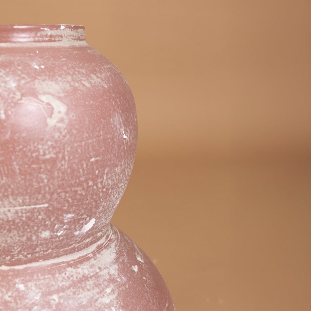 Closeup of rustic pink textured decorative vase showing detailed handcrafted finish and sculpted form ideal for artistic modern home decor.