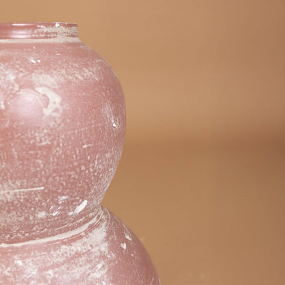 Closeup of rustic pink textured decorative vase showing detailed handcrafted finish and sculpted form ideal for artistic modern home decor.