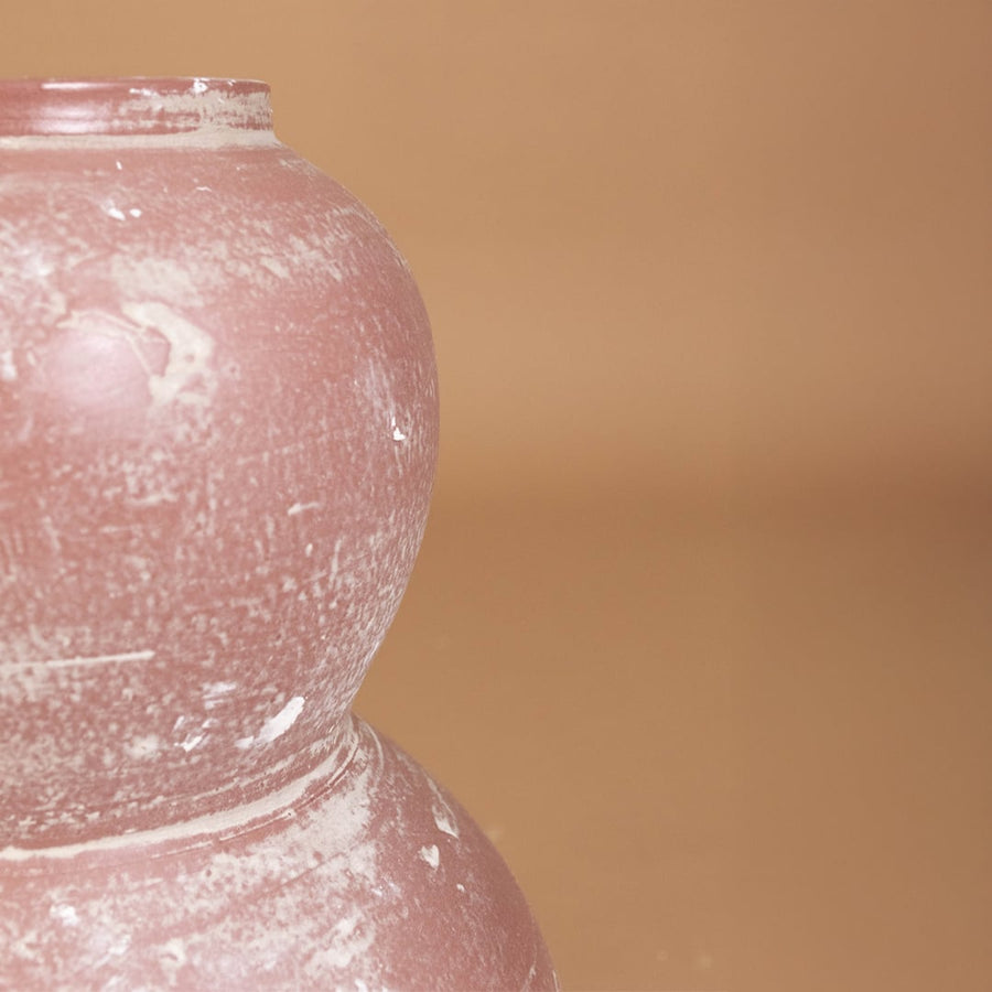 Closeup of rustic pink textured decorative vase showing detailed handcrafted finish and sculpted form ideal for artistic modern home decor.