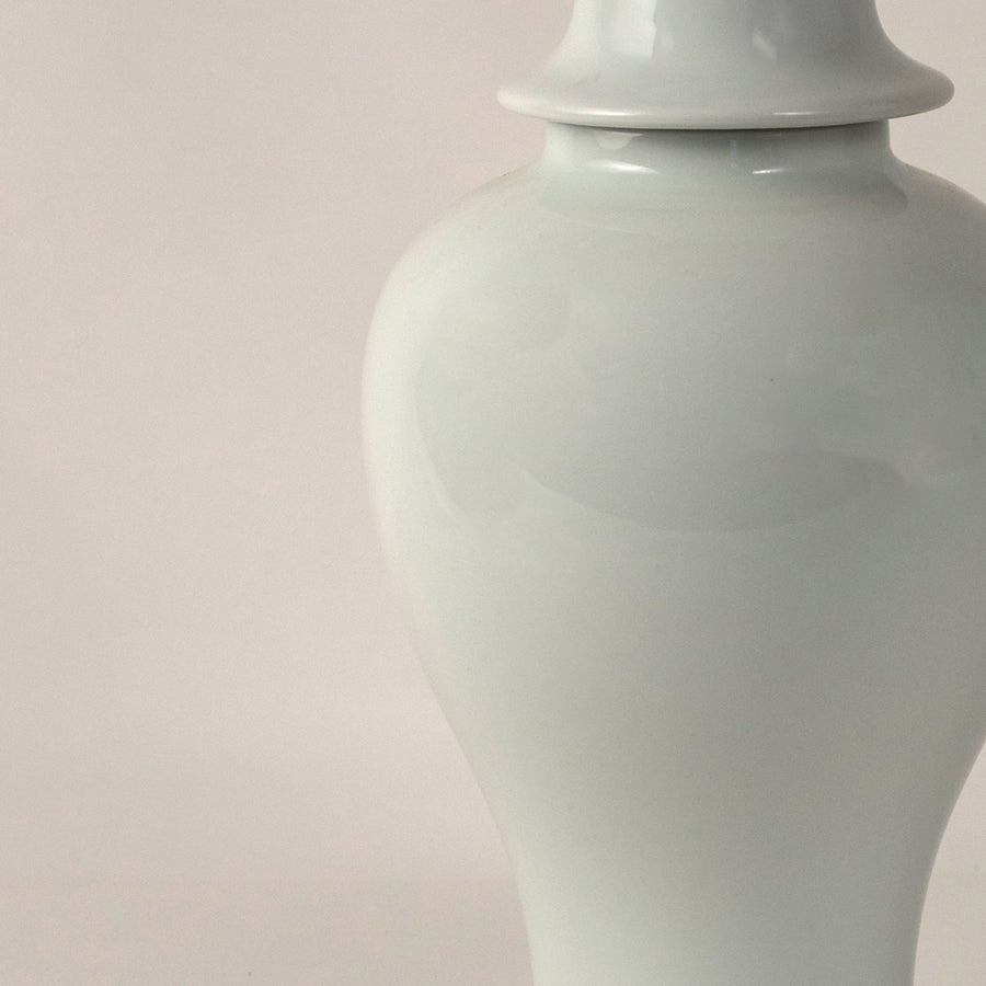 White ceramic pedestal vase with smooth finish placed on white surface against neutral background highlighting elegant minimal home decor aesthetic.