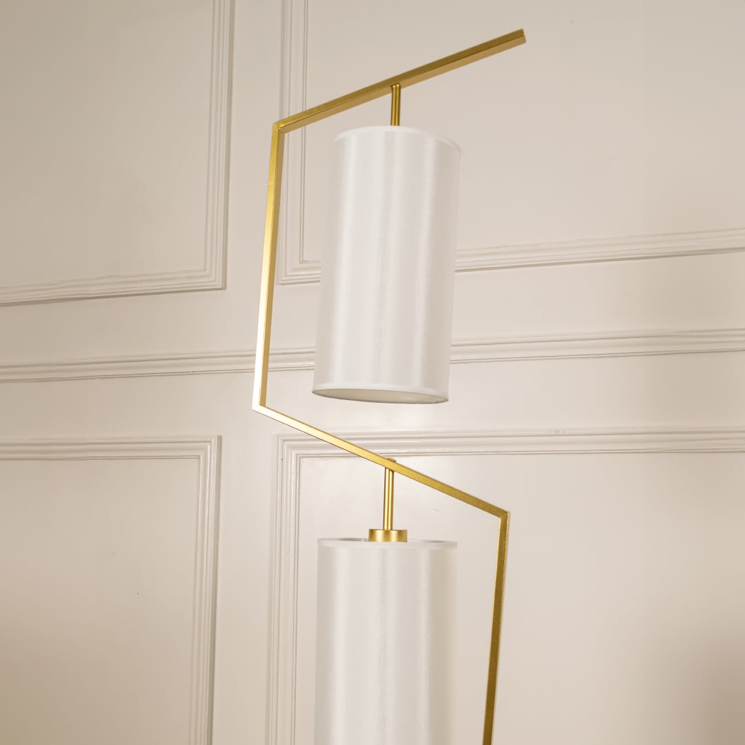 Closeup image of the marble base and golden stand of the floor lamp for a modern luxury touch.