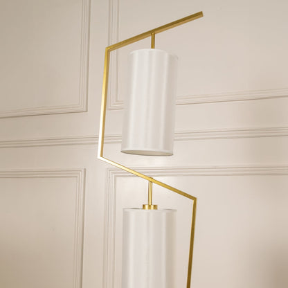 Closeup image of the marble base and golden stand of the floor lamp for a modern luxury touch.