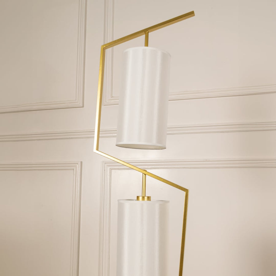 Closeup image of the marble base and golden stand of the floor lamp for a modern luxury touch.