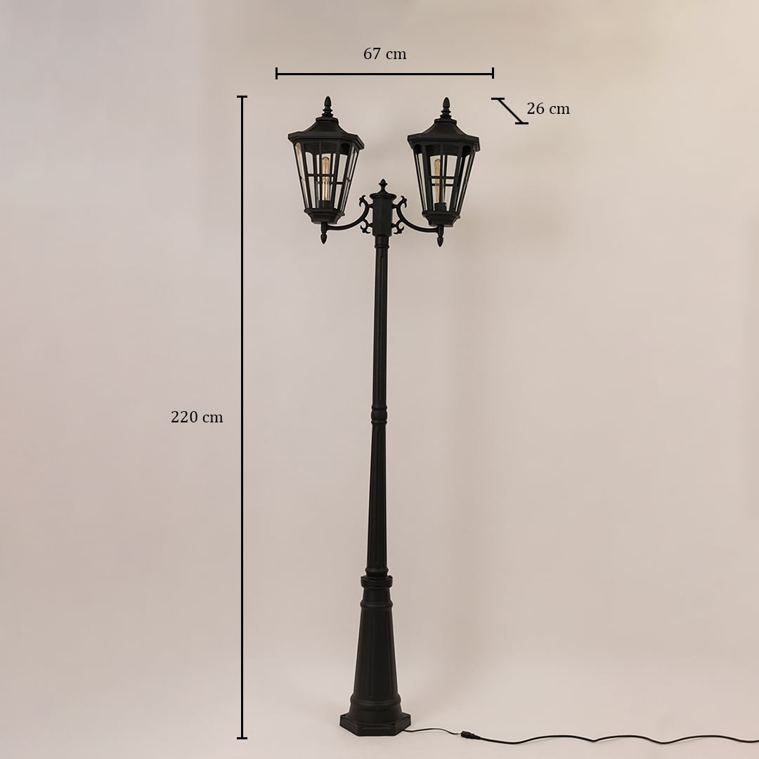 Black outdoor street lamp with dual heads shown with dimensions 220 cm height 67 cm width and 26 cm depth.