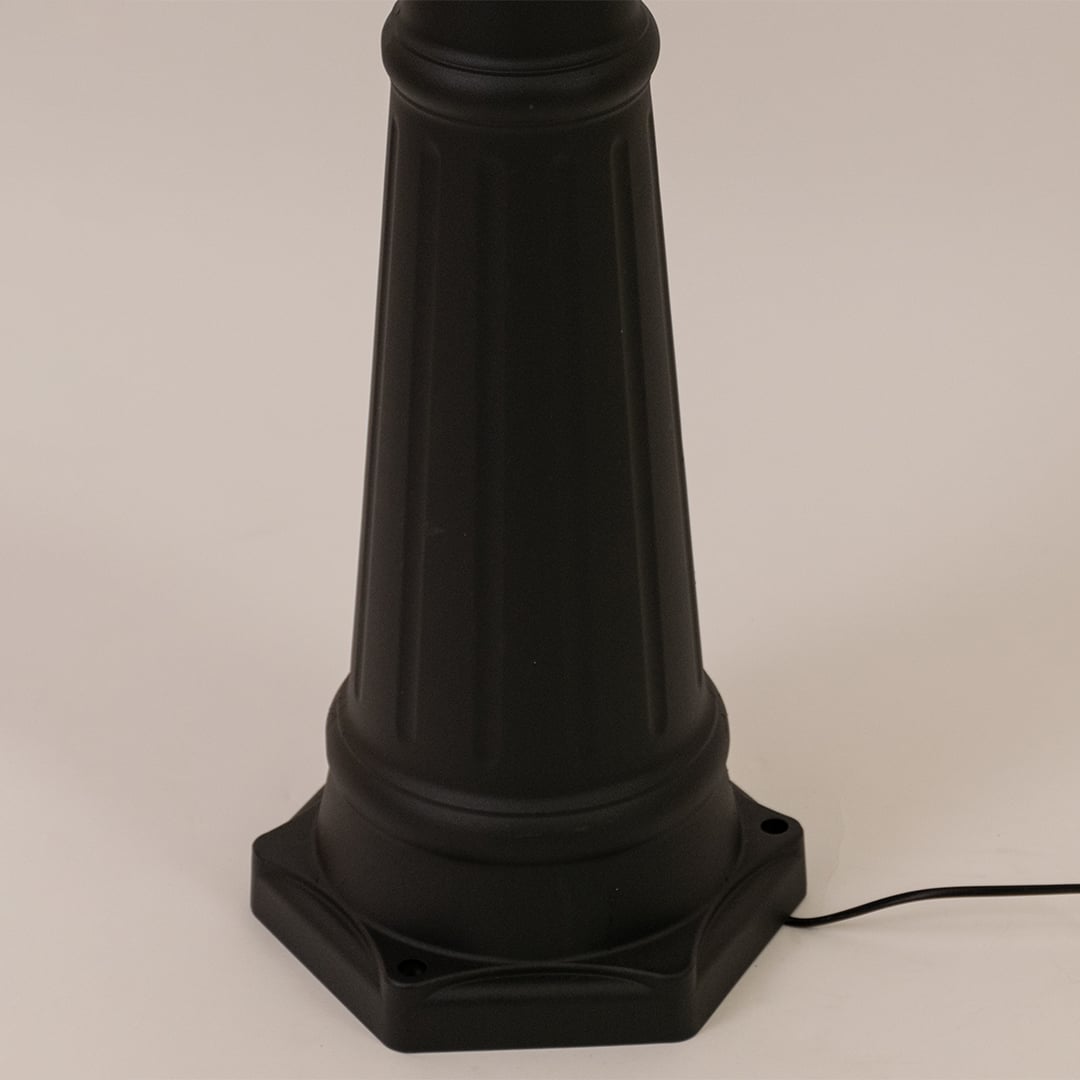 Closeup of black outdoor street lamp base with elegant metal finish for luxury exterior decor use.