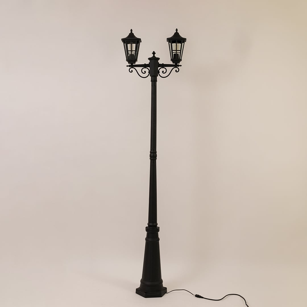 Vintage outdoor street lamp with triple lantern shades for elegant exterior decor styling use.