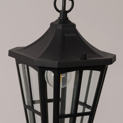 Closeup outdoor lantern in black metal with glass panels for entrance or garden decor lighting white background.