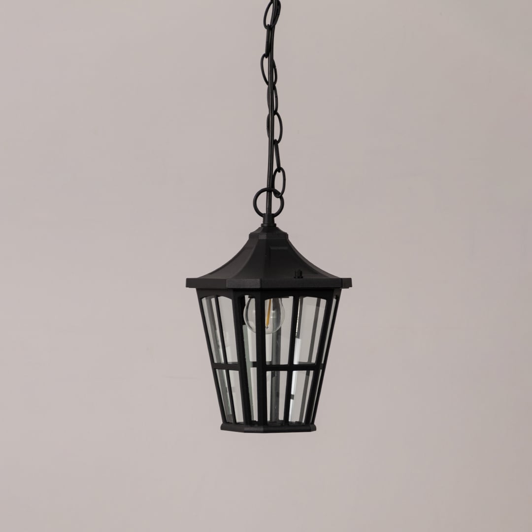 Stylish black outdoor hanging lantern with clear glass panels shown on white background perfect for porch and patio decor.
