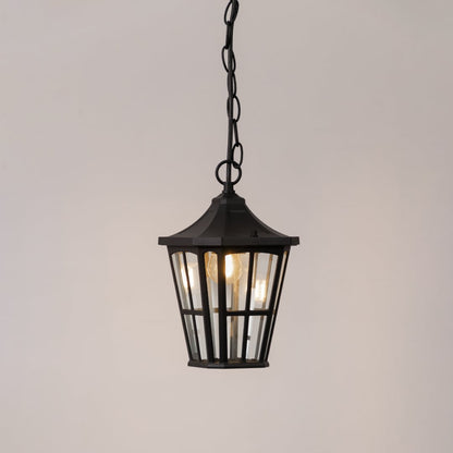 Elegant black outdoor hanging lantern glowing softly on white background ideal for porch garden or entry lighting decor.